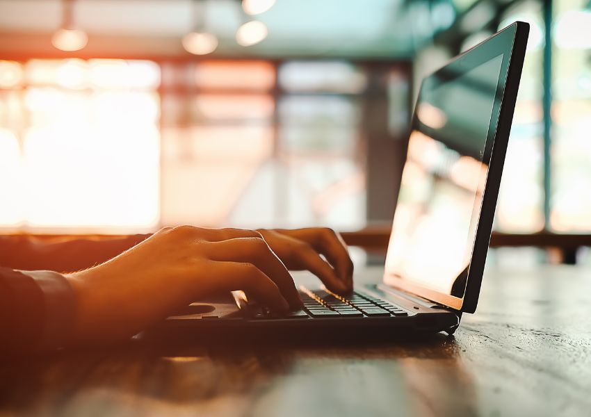 Laptop-With-Someone-Typing-On-It