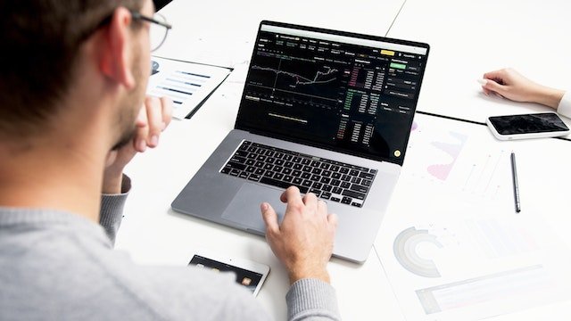 Person Using A Laptop With A Chart On The Screen