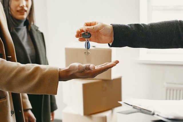 A-Landlord-Handing-Keys-To-New-Home-To-Another-Person