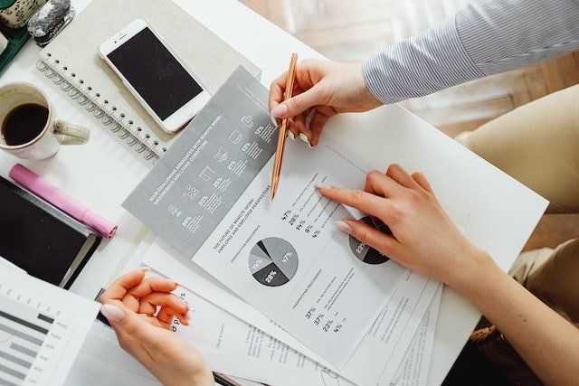 A-Person-Reading-Data-Documents-At-A-Desk