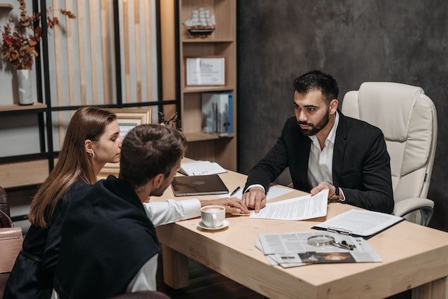 A-Person-Meeting-With-Two-Other-People-At-A-Desk